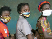 Girls wear their face masks during dignity kit distribution in Freetown