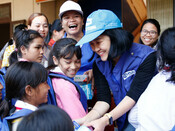Plan staff hand out menstrual hygiene products during distribution in Quang Tri province