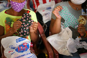 Young women learn how to use the reusable sanitary pads during training session