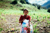 Girl carries home her hygiene kit from Plan International