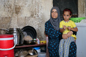 Amana with her youngest daughter at their home in Akkar district