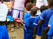 Children queue to receive their daily free school meal