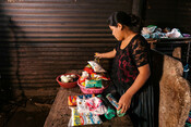Gloria, 18, looks at the groceries bought with Plan's support