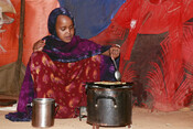 Najma, 11, prepares meal for her family in IDP camp